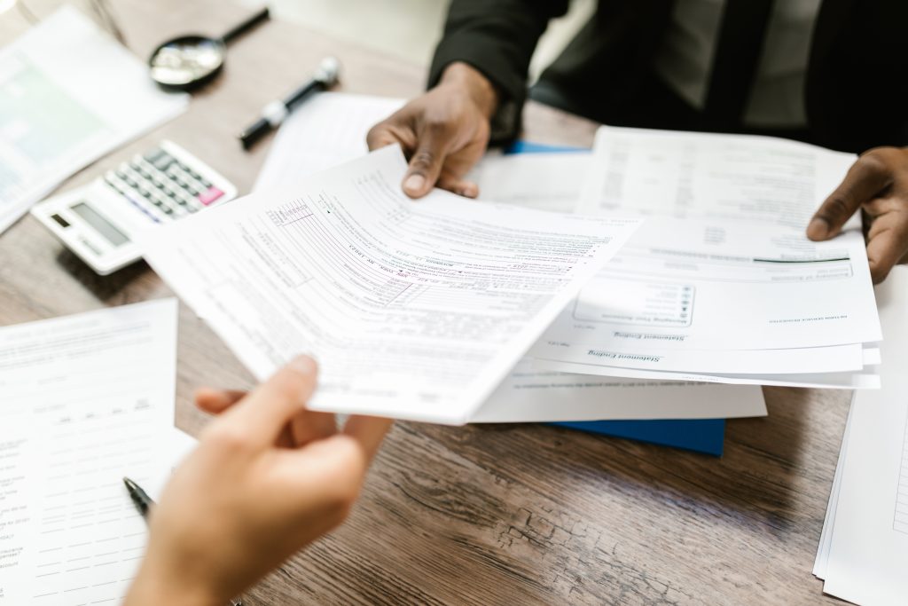 insurance paperwork being handed to a client