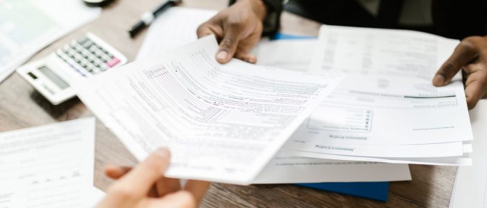 insurance paperwork being handed to a client