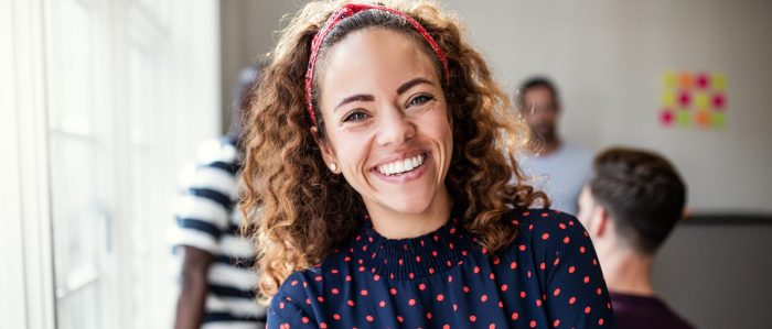 Smiling Female Designer Standing In An Modern Office