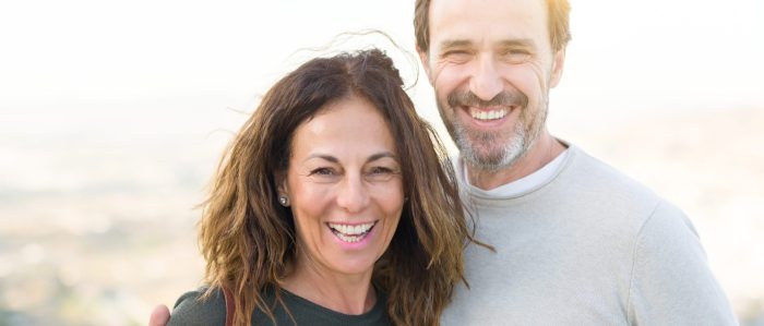 Romantic Couple Smiling And Cuddling On A Sunny Day