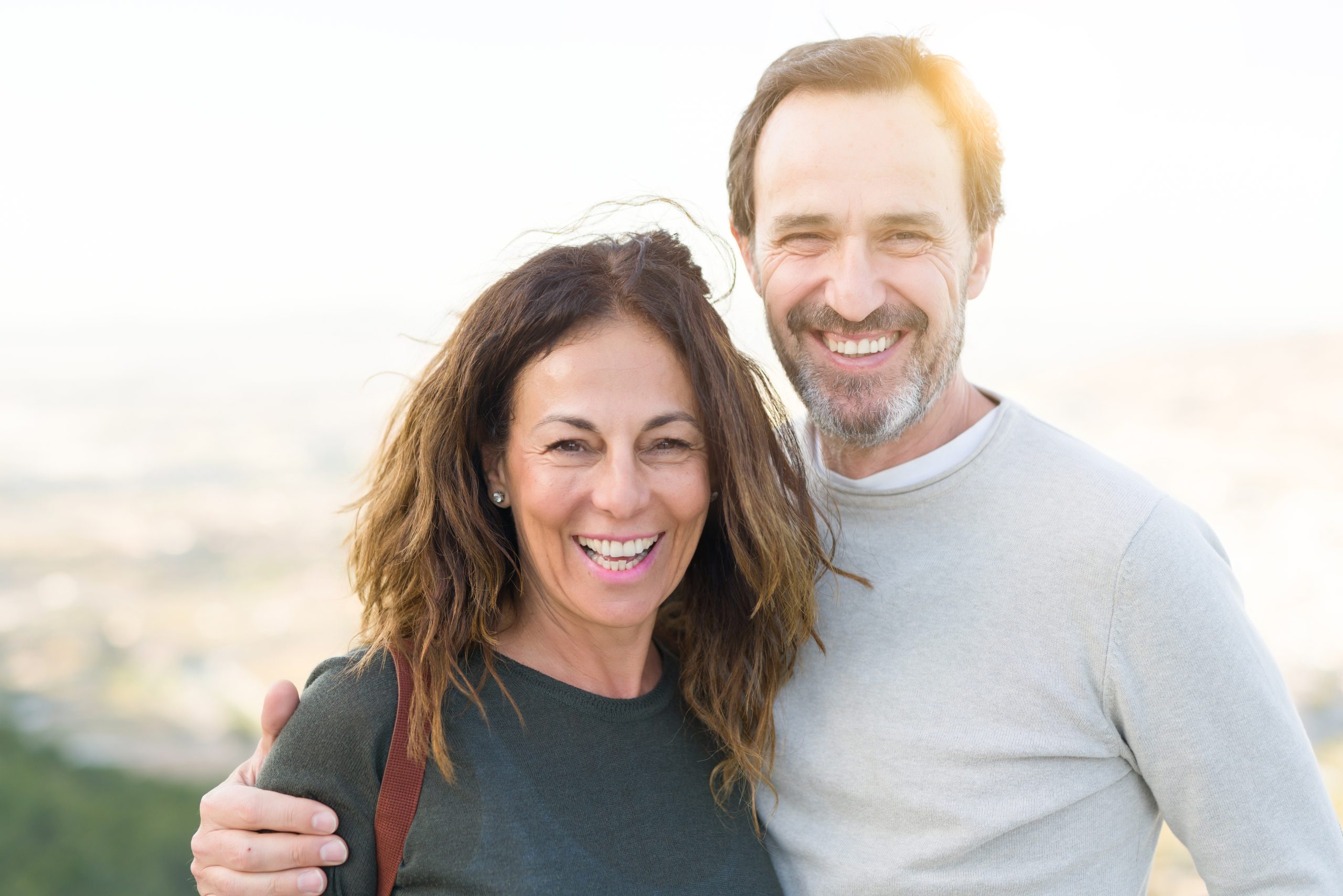 Romantic Couple Smiling And Cuddling On A Sunny Day